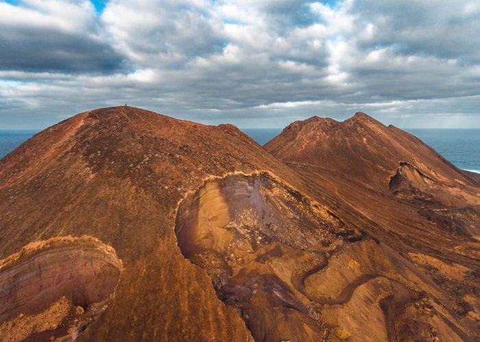 Aerial photos of Calhau, a village located near an inactive volcano in Sao Vicente Island, Cabo Verde, offer a unique perspective of the towering volcanic landscape, rugged terrain, and vibrant coasta