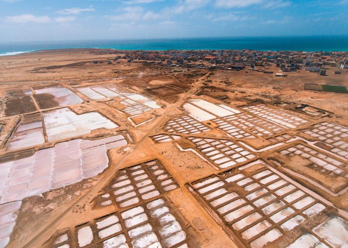 Aerial photos of Salines in Santa Maria, Sal Island in Cabo Verde showcase stunning salt flats, colorful patterns created by salt ponds, machinery used for salt harvesting