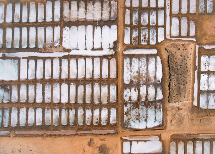 Aerial photos of Salines in Santa Maria, Sal Island in Cabo Verde showcase stunning salt flats, colorful patterns created by salt ponds, machinery used for salt harvesting